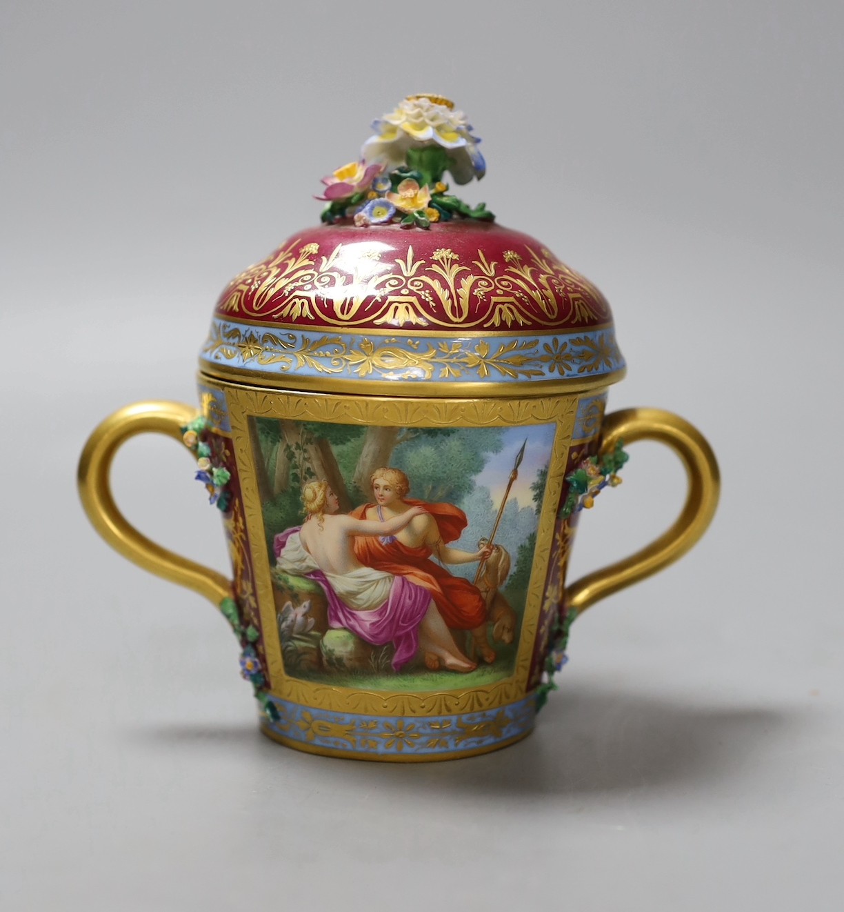 A Vienna style two handled porcelain chocolate cup and cover, c.1900, 13cms high